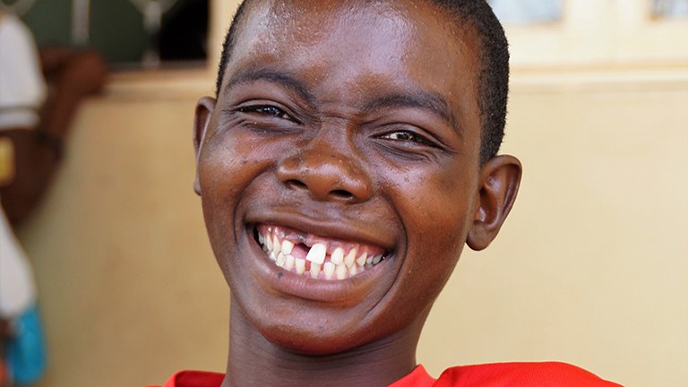 Image of an adolescent boy smiling.