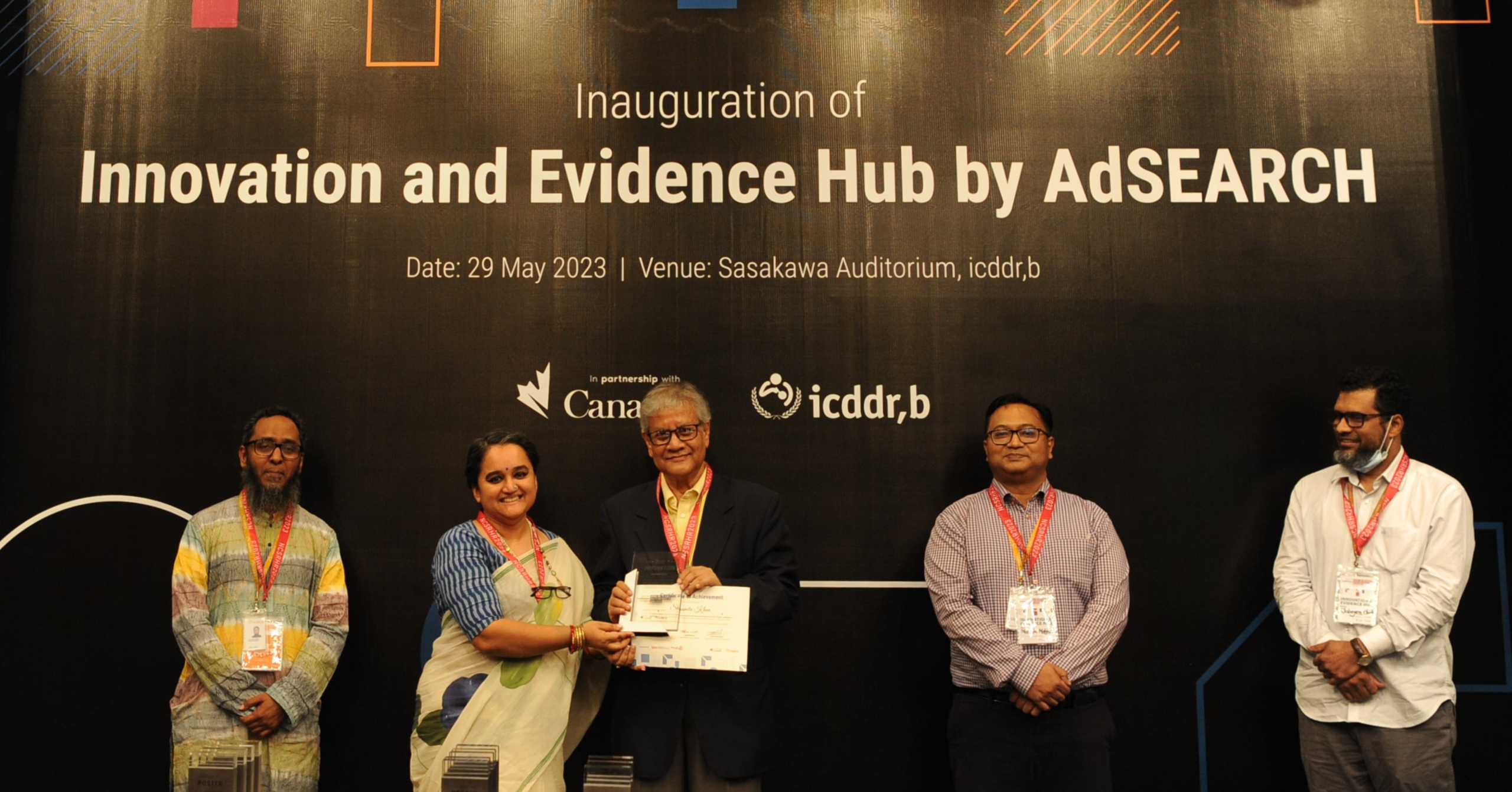 D4I’s Knowledge Management and Communications Specialist accepts the grant from the Global Affairs Canada-funded Advancing Sexual and Reproductive Health and Rights (AdSEARCH) project in Dhaka, Bangladesh