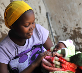 Photo showing a newborn baby being held by her mother in their home in Mtwara, Tanzania.